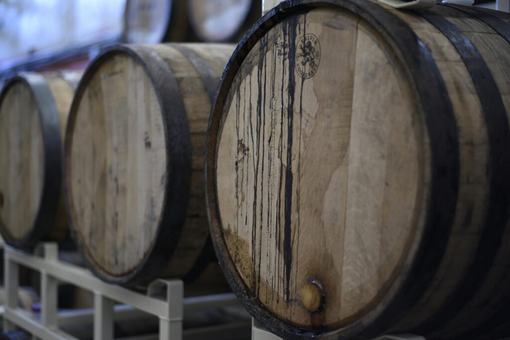 Close-up of wooden wine barrels in a cellar