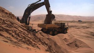Flat tyre on a heavy-duty construction vehicle, showing damage and downtime on a rocky worksite.